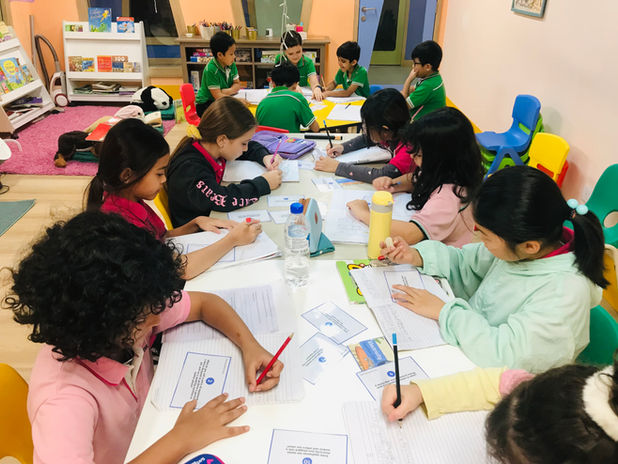 Primary learners working together at a table