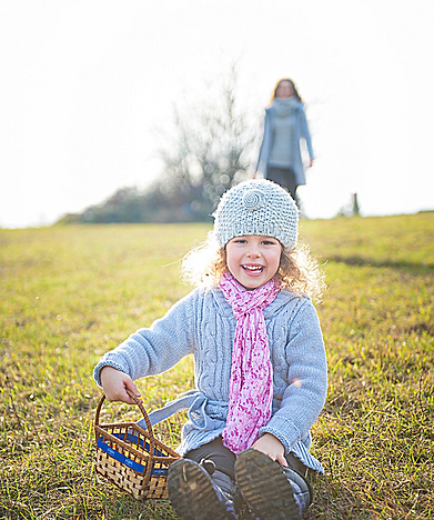 Child sitting outdoors in a field